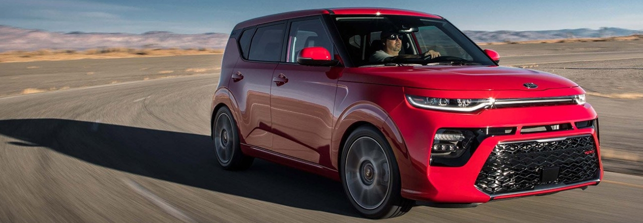 Red 2020 Kia Soul driving through desert